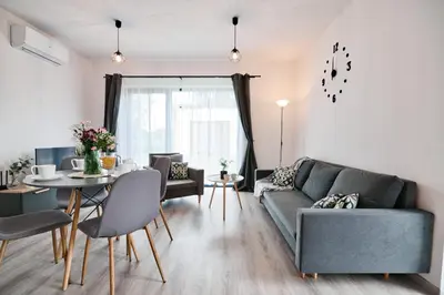 a living room with a couch and a table at Domki na Sosnowej by Housine in Zator