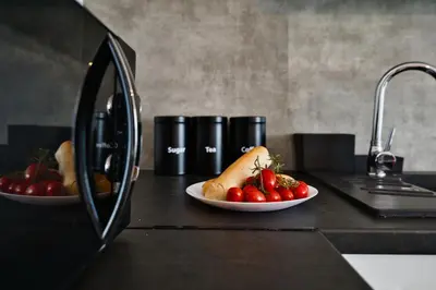two plates of food on a counter with strawberries at Domki na Sosnowej by Housine in Zator