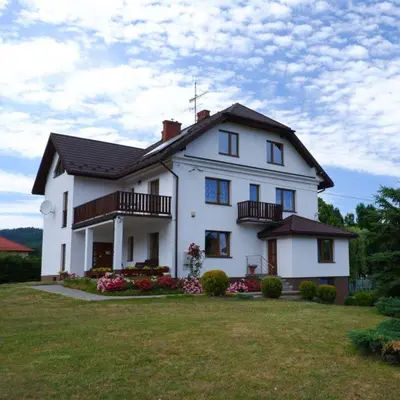 a large white house with a large yard at Willa Tulipan in Kamienica