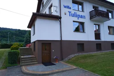 a building with a sign on the side of it at Willa Tulipan in Kamienica