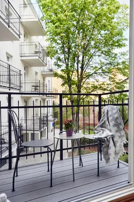 a patio with two chairs and a table on a balcony at Pola Apartament Old Town - Kazimierz in Kraków