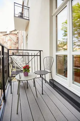 a balcony with two chairs and a table at Pola Apartament Old Town - Kazimierz in Kraków