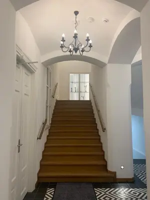 a staircase in a house with a chandelier at Pola Apartament Old Town - Kazimierz in Kraków