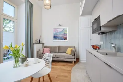 a kitchen and living room with a couch at Pola Apartament Old Town - Kazimierz in Kraków