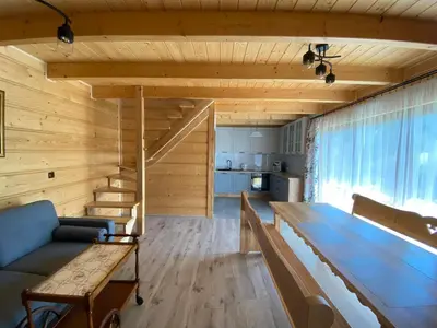 a living room with a couch and a table at Gładyszówka - Chatka w Gorcach in Ponice