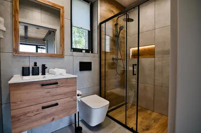 a bathroom with a shower and a toilet and a sink at Domki na Wiśniowej Zator in Zator