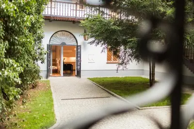 a view of a house through a fence at Sewa Apartments in Kraków