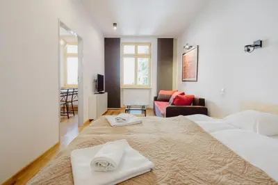a bedroom with two white towels on a bed at Sewa Apartments in Kraków