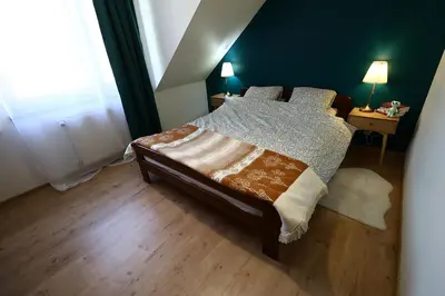 a bedroom with a bed and a window at Rabczański Apartament in Rabka-Zdroj