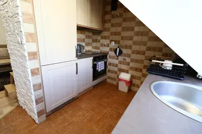 a small kitchen with a sink and a stove at Rabczański Apartament in Rabka-Zdroj
