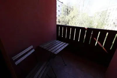a balcony with a bench and a window at Rabczański Apartament in Rabka-Zdroj