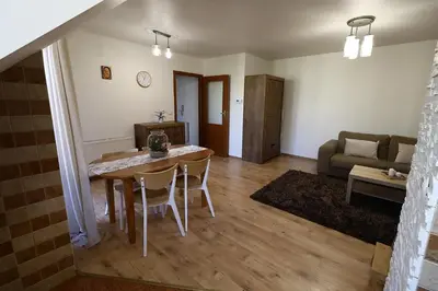 a living room with a table and chairs and a couch at Rabczański Apartament in Rabka-Zdroj