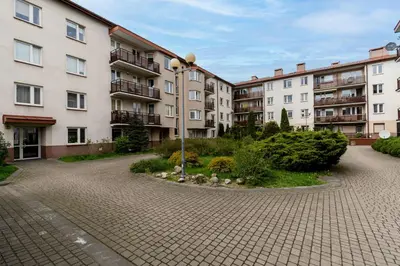a row of apartment buildings in a courtyard at Sunny Kliny Apartment in Kraków