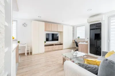 a living room with a couch and a table at Sunny Kliny Apartment in Kraków