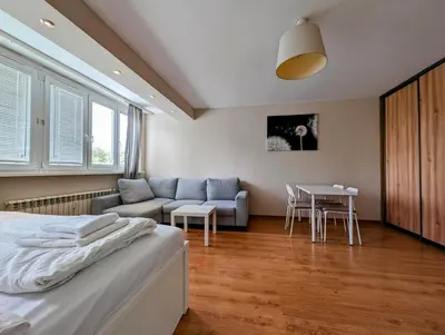 a bedroom with a bed and a couch and a table at Kazimierza Wielkiego 87 by Homeprime in Kraków