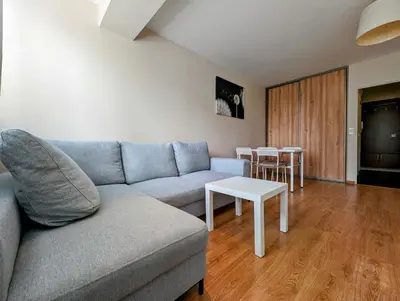 a living room with a couch and a table at Kazimierza Wielkiego 87 by Homeprime in Kraków