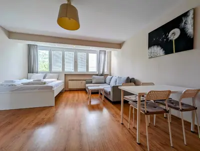 a living room with a bed and a table at Kazimierza Wielkiego 87 by Homeprime in Kraków