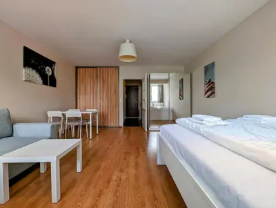 a bedroom with two beds and a table and chairs at Kazimierza Wielkiego 87 by Homeprime in Kraków