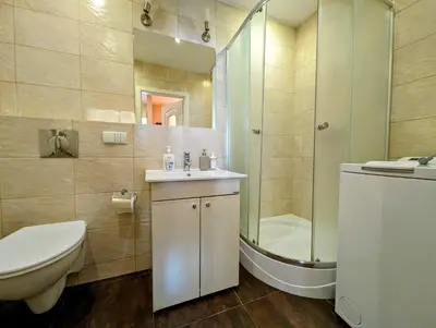 a bathroom with a toilet and a sink and a shower at Kazimierza Wielkiego 87 by Homeprime in Kraków