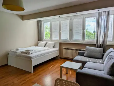 a living room with a bed and a couch at Kazimierza Wielkiego 87 by Homeprime in Kraków