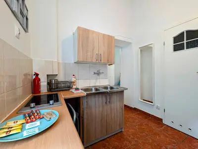 a kitchen with a sink and a counter with a plate on it at Wiślna 4 by Homeprime in Kraków