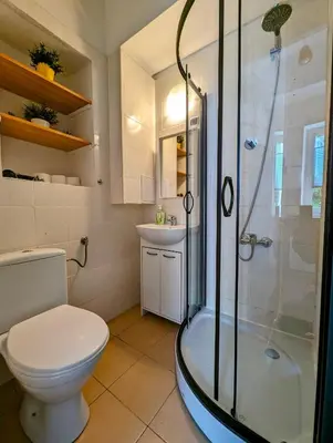 a bathroom with a shower and a toilet and a sink at Wiślna 4 by Homeprime in Kraków