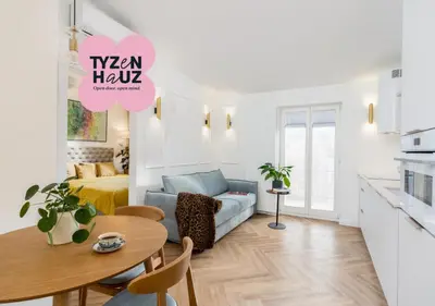 a living room with a couch and a table at Mostowa Street by Tyzenhauz in Kraków