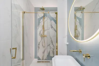 a bathroom with a shower with a toilet and a mirror at Mostowa Street by Tyzenhauz in Kraków