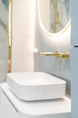 a bathroom with a white sink and a mirror at Mostowa Street by Tyzenhauz in Kraków