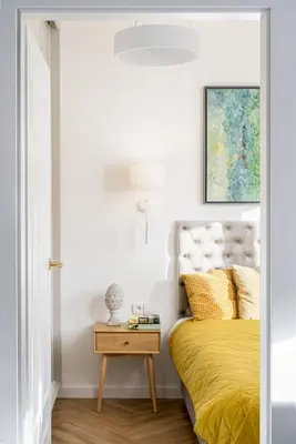 a bedroom with a yellow bed and a table at Mostowa Street by Tyzenhauz in Kraków