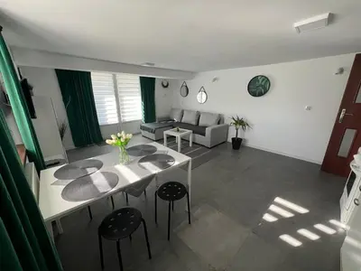 a living room with a table and a couch at Apartament Koninki in Poręba Wielka