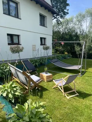 a yard with two chairs and a swing at Apartament Koninki in Poręba Wielka