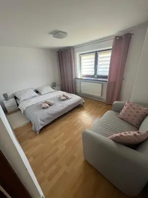 a bedroom with two beds and a couch at Apartament Koninki in Poręba Wielka