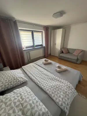 a bedroom with two beds and a couch at Apartament Koninki in Poręba Wielka