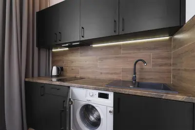 a kitchen with a washing machine and a sink at Apartment with balcony - Rakowicka 6 Street in Kraków