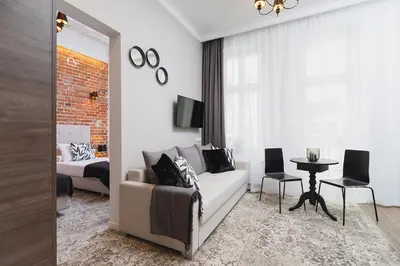 a living room with a couch and a bedroom at Apartment with balcony - Rakowicka 6 Street in Kraków