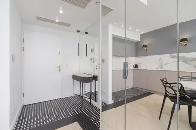 a kitchen with glass walls and a table and chairs at Augustianska - Private parking - Kazimierz District in Kraków