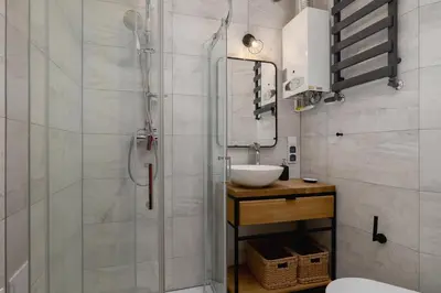 a bathroom with a sink and a glass shower at 3 bedroom apartment-Aleja Daszyńskiego- Grzegórzki in Kraków