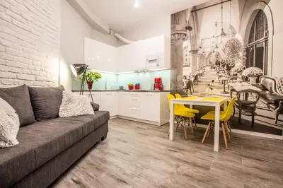 a living room with a couch and a table and a kitchen at 1-bedroom apartment - Kazimierz- Starowiślna 54 in Kraków