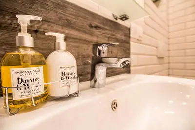 a bathroom sink with two bottles of soap on it at 1-bedroom apartment - Kazimierz- Starowiślna 54 in Kraków