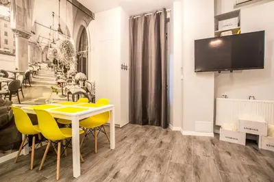 a dining room with a table and yellow chairs at 1-bedroom apartment - Kazimierz- Starowiślna 54 in Kraków