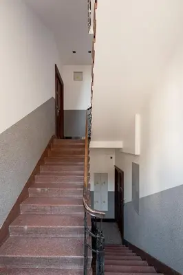 a staircase in a building with a stair railing at Studio Apartment - Rzeszowska 4 Street in Kraków