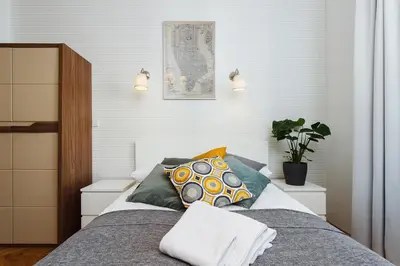 a bedroom with a bed with a pillow on it at Studio Apartment - Rzeszowska 4 Street in Kraków