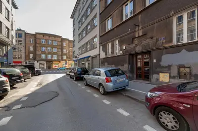 a city street with cars parked on the street at Studio Apartment - Rzeszowska 4 Street in Kraków