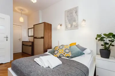 a bedroom with a bed with two towels on it at Studio Apartment - Rzeszowska 4 Street in Kraków