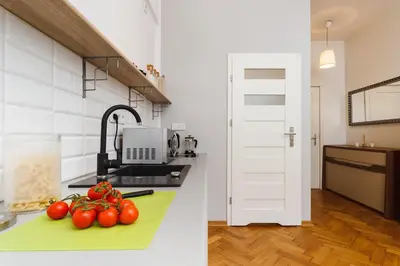 a kitchen with tomatoes on a green counter top at Studio Apartment - Rzeszowska 4 Street in Kraków