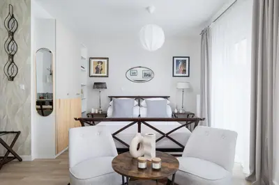 a living room with two chairs and a table at Luxury Studio - Lwowska 10 street in Kraków