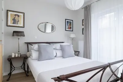 a bedroom with a white bed and a mirror at Luxury Studio - Lwowska 10 street in Kraków