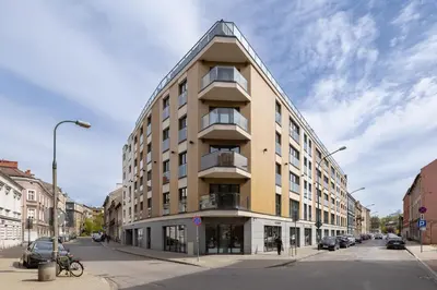 an apartment building on a street with cars parked at Luxury Studio - Lwowska 10 street in Kraków