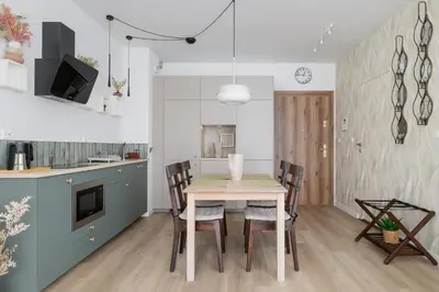 a kitchen and dining room with a table and chairs at Luxury Studio - Lwowska 10 street in Kraków